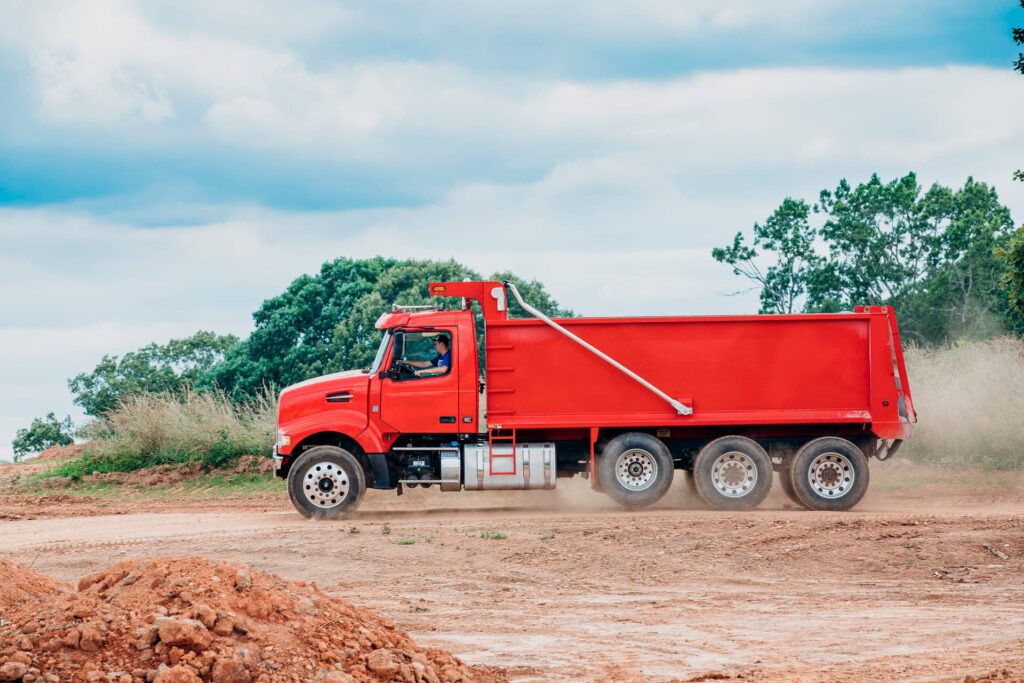 Heavy-duty Carolina Dump Trucking hauling crushed stone and sand in North Carolina for construction projects. Reliable freight services for your material needs.